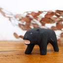 Wooden figurine of a black panther, with a growling expression.