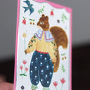 Side view of a postcard to show a silver foil shine.