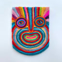 Colorful felted wool artwork, mostly flat, of a face.