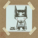 Marker illustration of a small character with a simple, smiling face wearing a black cap with 2 pointed cat like ears. Piece is taped to cardboard backing.