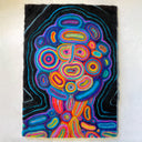 Artwork made out of tufted felt on flat, canvas like surface of an abstract portrait with many colors.