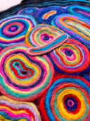 Close-up of colorful yarn rolls with vibrant spiral patterns.