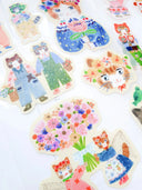 Set of decorative stickers featuring cartoon cats and foxes in various outfits on a white background.
