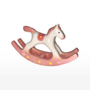 Pink rocking horse ceramic sculpture on a white background