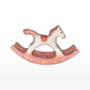 Pink rocking horse ceramic sculpture on a white background