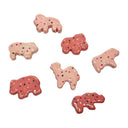 Set of ceramic pink animal-shaped cookies with colorful sprinkles on a white background
