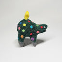 Needle felted wool sculpture of a dark green rounded body quadruped creature with an open mouth smile and small black eyes. Its body has colorful polkadots, like lights on a Christmas tree and a felted yellow star on top.