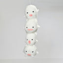 Needle felted sculpture of a stack of 4 cute, simplistic white blob characters with tiny limbs and pink mouthed smiles. They stand in various poses.
