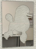 Mirrored surface with a stencil cut out of a poodle with a wide tooth smile.  