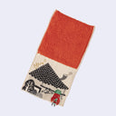 Rectangular textile with a pocket, the top can be folded over to make it into a pouch. Interior is bright orange and exterior is beige with designs of a triangular tiled roof with a clothesline and a red demon hanging off of it.