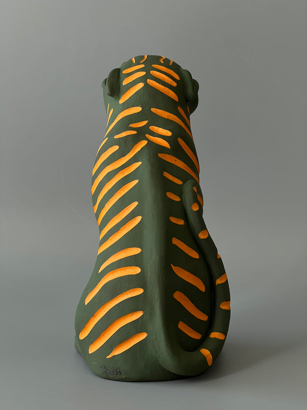 Matte finish ceramic sculpture of a green tiger with orange stripes, sitting on its hindlegs and with an open mouth smile