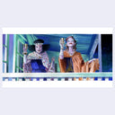Two animated characters in ornate costumes holding drinks against a colorful background