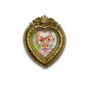 A heart-shaped ornate gold-toned frame with a colorful illustration of a creepy, wide-eyed white-faced creature inside, set against a plain white background.