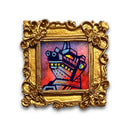 Miniature painting of a kaiju monster in a gold frame on a white background