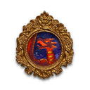 Miniature painting of a kaiju monster in a gold frame on a white background