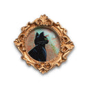 Painting of a black cat in a small, gold ornately designed frame.