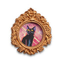 Painting of a small, cute cartoon cat against a colorful sky. Framed in a tiny gold, ornately designed frame.