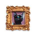 Painting of a small, cute cartoon cat against a colorful sky. Framed in a tiny gold, ornately designed frame.