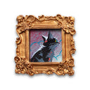 Painting of a small, cute cartoon cat against a colorful sky. Framed in a tiny gold, ornately designed frame.
