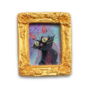 Painting of a small, cute cartoon cat against a colorful sky. Framed in a tiny gold, ornately designed frame.