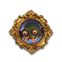 A decorative oval brooch or pendant featuring a painted monster face with large orange eyes and red tentacles, set within an ornate gold frame on a white background.