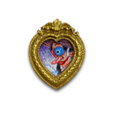 A heart-shaped gold frame featuring a colorful, surreal art illustration of a single large blue eye with red and black details, set against a plain white background.