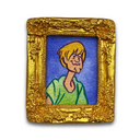 A square gold picture frame with an ornate floral border, containing a hand-drawn cartoon portrait of a blond person against a blue background, shown on a white background.