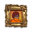 A small framed portrait artwork featuring a cartoon-style figure with short reddish-brown hair, blue glasses, and an orange top, set inside an ornate gold frame on a white background.