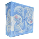 Painting mostly in blues of 2 small mermaid creatures, with fish tails and fins. They have long white hair and seashells behind their ears.