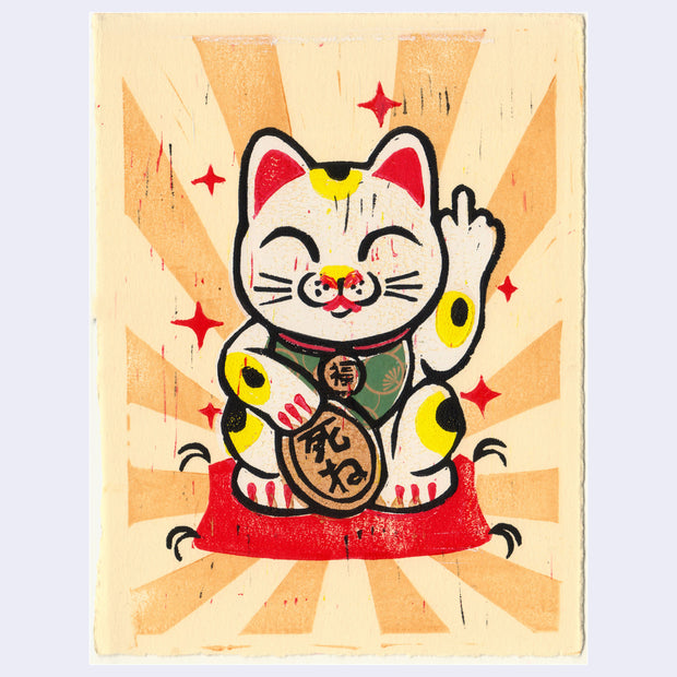 Relief print of a classic maneki cat, white with gold and black spots. It holds a token in its paw and sits atop a cushion. Its eyes are closed and it holds up a middle finger.