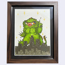 Framed illustration of a green monster over a cityscape with decorative elements.