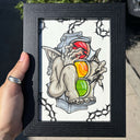 Framed artwork of a gargoyle with a traffic light on a white background
