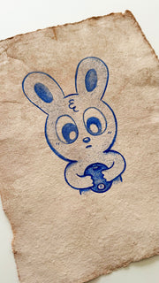 Color pencil drawing of a blue cartoon bunny holding a magic 8 ball.