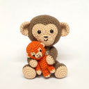 Two crocheted monkey toys, one larger and one smaller, on a white background.