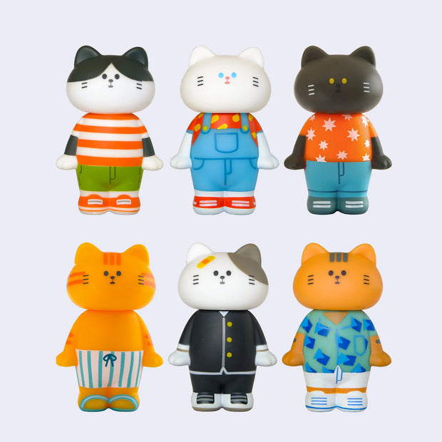 6 vinyl figures of cats dressed in various outfits such as t-shirts, overalls and summer outfits.