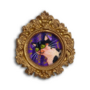 An ornate gold baroque-style oval frame featuring a colorful illustration of a black and white cat with green eyes on a purple background, shown against a plain white backdrop.