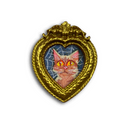 A heart-shaped gold brooch featuring a miniature illustration of a brown striped cat on a spiderweb background, shown on a plain white background.