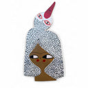 Die cut painted wood art piece of a woman with white hair and polka dot patterns. Forming out of her hair is a bird, with a large pink beak.