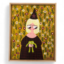 Framed artwork of a character with a witch hat holding a frog, set against a floral background.
