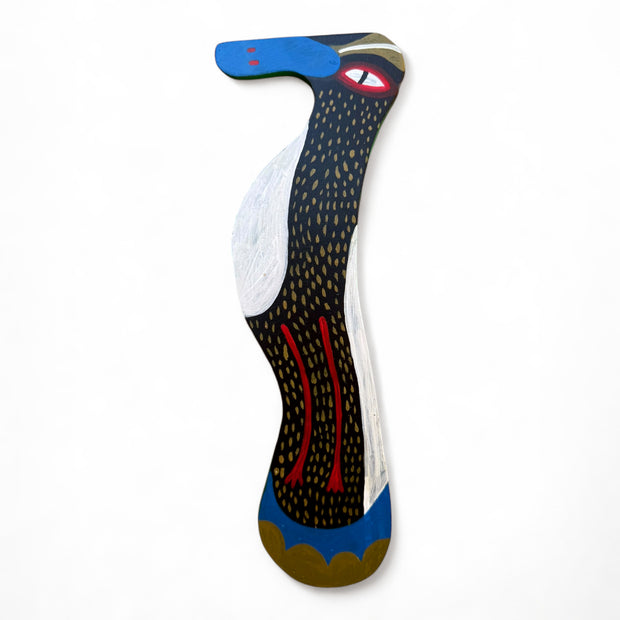 Painting on a flat die cut wood of a bird, mostly black with yellow spots and a blue beak.