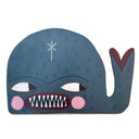 Whale-shaped painting with a blue body, white eyes, and red mouth. It has a slightly angry expression, showing many sharp teeth.