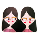 Flat painted wooden sculpture of 2 girls, twins, joined together by their long black hair.