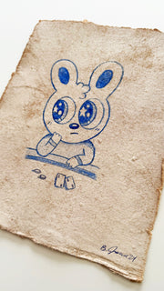 Blue color pencil drawing of a cartoon bunny sitting at a card table.