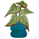 A stylized decorative plant cutout with green leaves dotted with white spots and outlined in red, set in a teal pot against a plain white background.