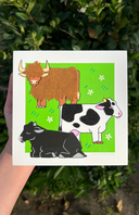 Illustrations of a brown bull, black and white cow, and black cow on a green background with flowers.