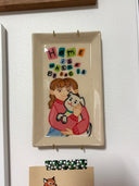 Rectangular ceramic tray with a painting in the inner dish of a girl holding a white cartoon dog. Colorful text overhead reads "Home is where my dog is"