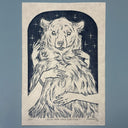 Blue ink linocut print of a fluffy bear, standing and seen from the belly upwards. 2 pairs of hands caress its fur.