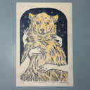 Blue ink linocut print of a fluffy bear, with some color, standing and seen from the belly upwards. 2 pairs of hands caress its fur.