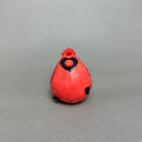 Ceramic sculpture of a very chubby red cardinal bird with black color accents and a hold in its head to act as a vase.