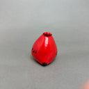 Ceramic sculpture of a very chubby red cardinal bird with black color accents and a hold in its head to act as a vase.